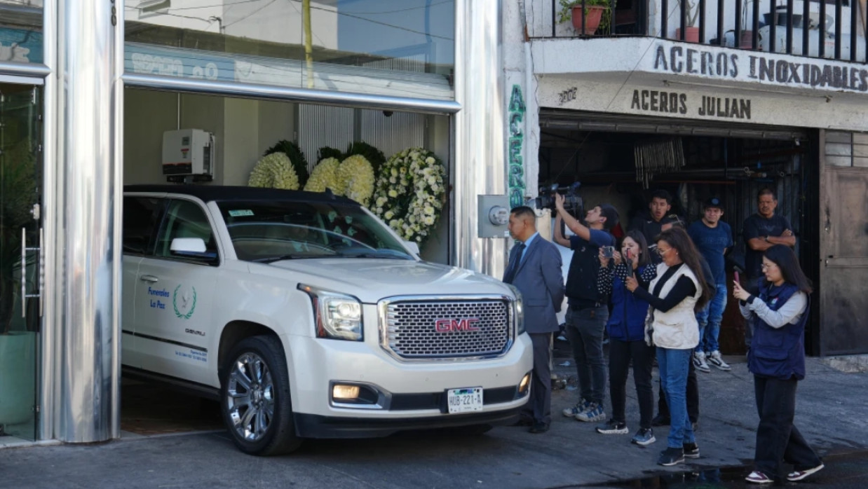 Journalists take photos and videos of a car carrying the remains of who authorities identified as the late Jalisco New Generation Cartel leader Nemesio Oseguera