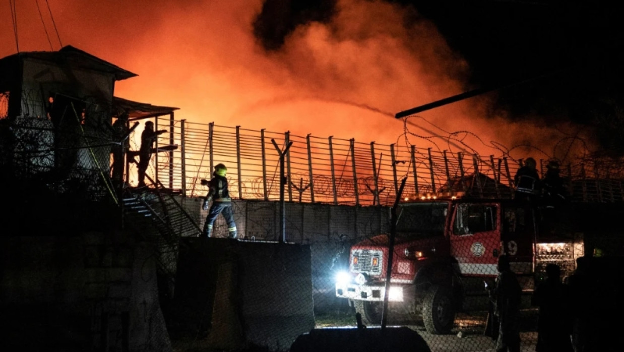Afghan firefighters and Taliban security personnel working to extinguish a fire at a drug rehabilitation hospital in Kabul