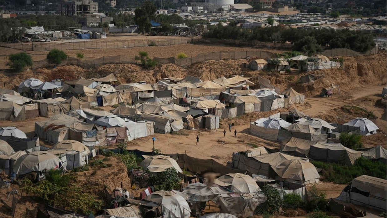 Palestinian children play in an open area at a makeshift camp for displaced people in Deir al-Balah, central Gaza Strip