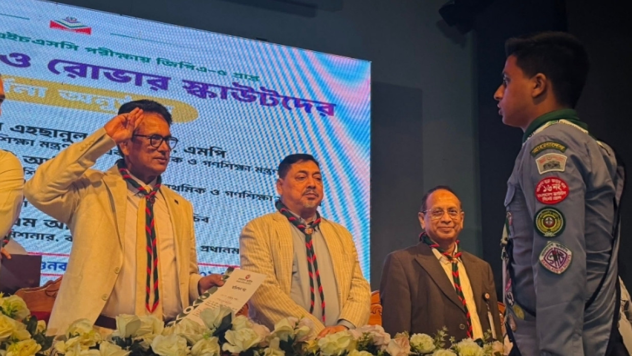 Education Minister Dr. A.N.M. Ehsanul Hoque Milon handing over certificates to a scout
