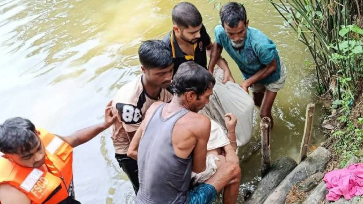 পুকুর থেকে মরদেহ উদ্ধার করা হচ্ছে