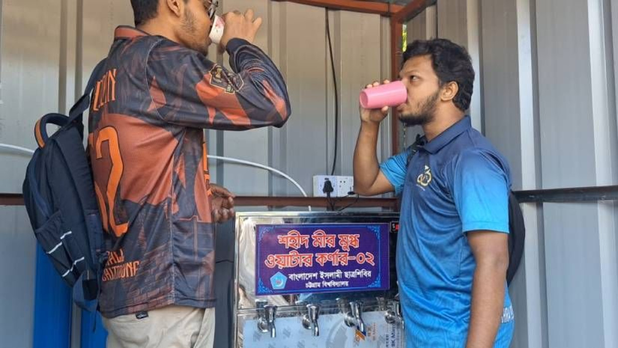 শহীদ মীর মুগ্ধের নামে ওয়াটার কর্নারে পানি পান করছেন দুজন শিক্ষার্থী