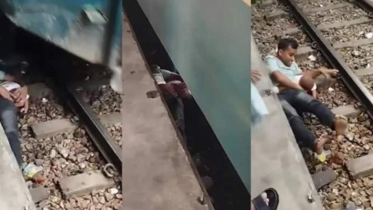 সন্তানকে বুকে জাপটে ধরে রেললাইনের ওপর স্থির হয়ে শুয়ে থাকলেন বাবা