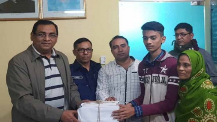 মাহিনের হাতে বই তুলে দিচ্ছেন দেলওয়ার হোসেন