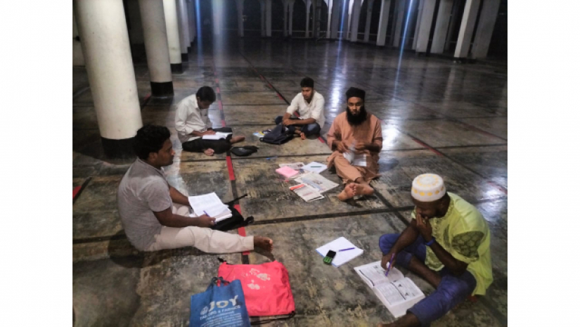 গণগ্রন্থাগার বন্ধ থাকায় ঢাকা বিশ্ববিদ্যালয় কেন্দ্রীয় মসজিদের বারান্দায় বসে পড়ছেন একদল বিসিএস প্রত্যাশী। 