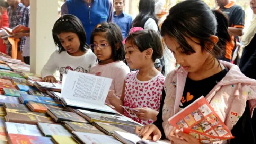 মেলায় বই দেখছে পাঠকরা