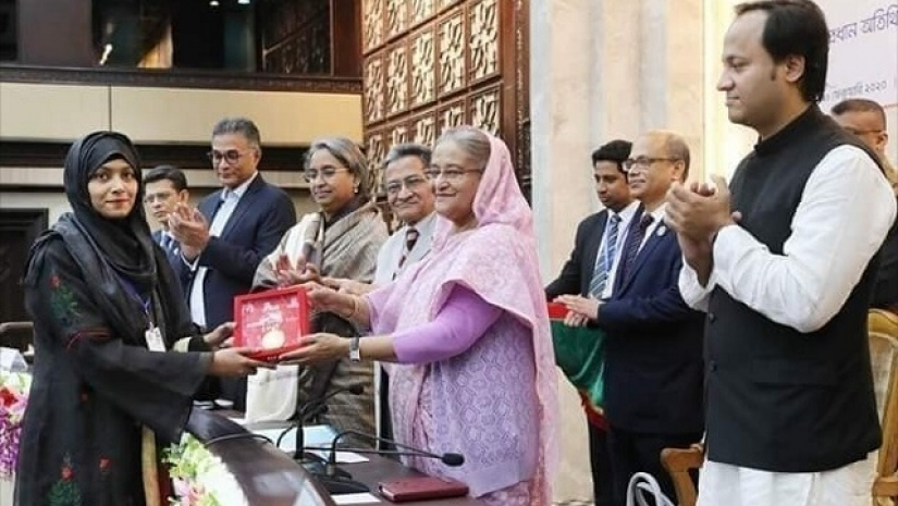 প্রধানমন্ত্রী স্বর্ণপদক গ্রহণ করছেন তাবাসসুম ইসলাম নবনী
