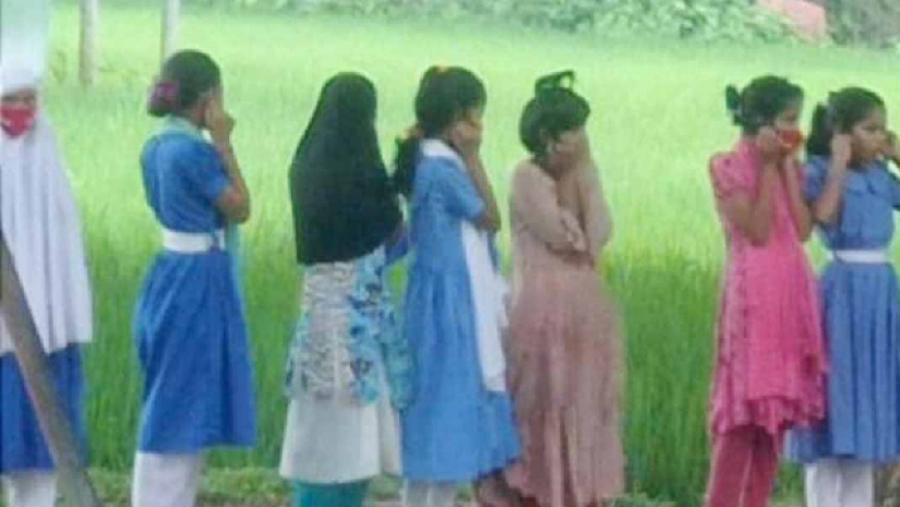 রোদে কান ধরে দাড়িয়ে থাকা শিক্ষার্থীরা